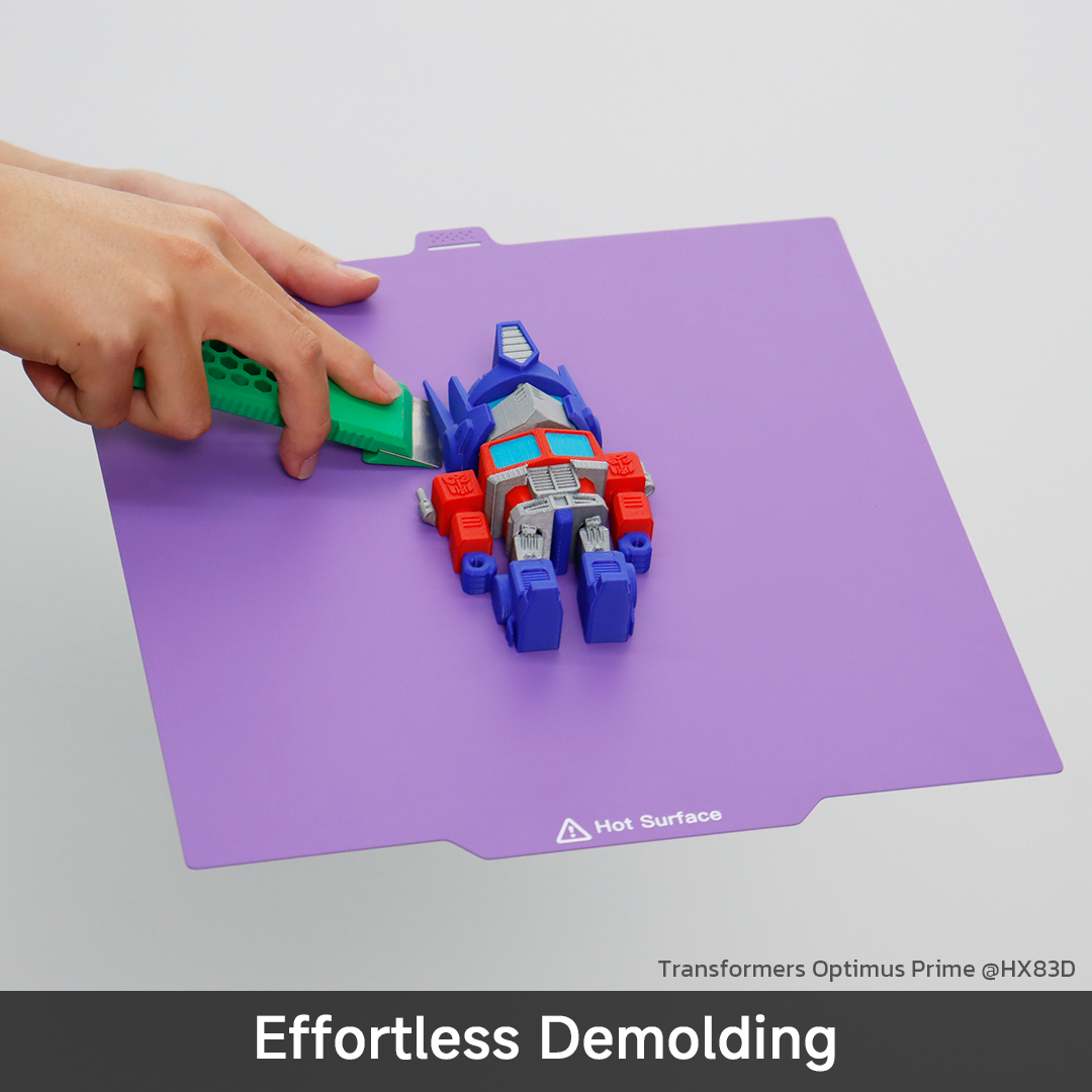Removing the Transformers Optimus Prime 3D print from QIDI Cool Plate Pro using a scraper